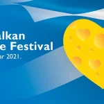 Najava za 12. Balkan Cheese Festival. Pozadina je grčka zastava sa sirom u obliku srca.
