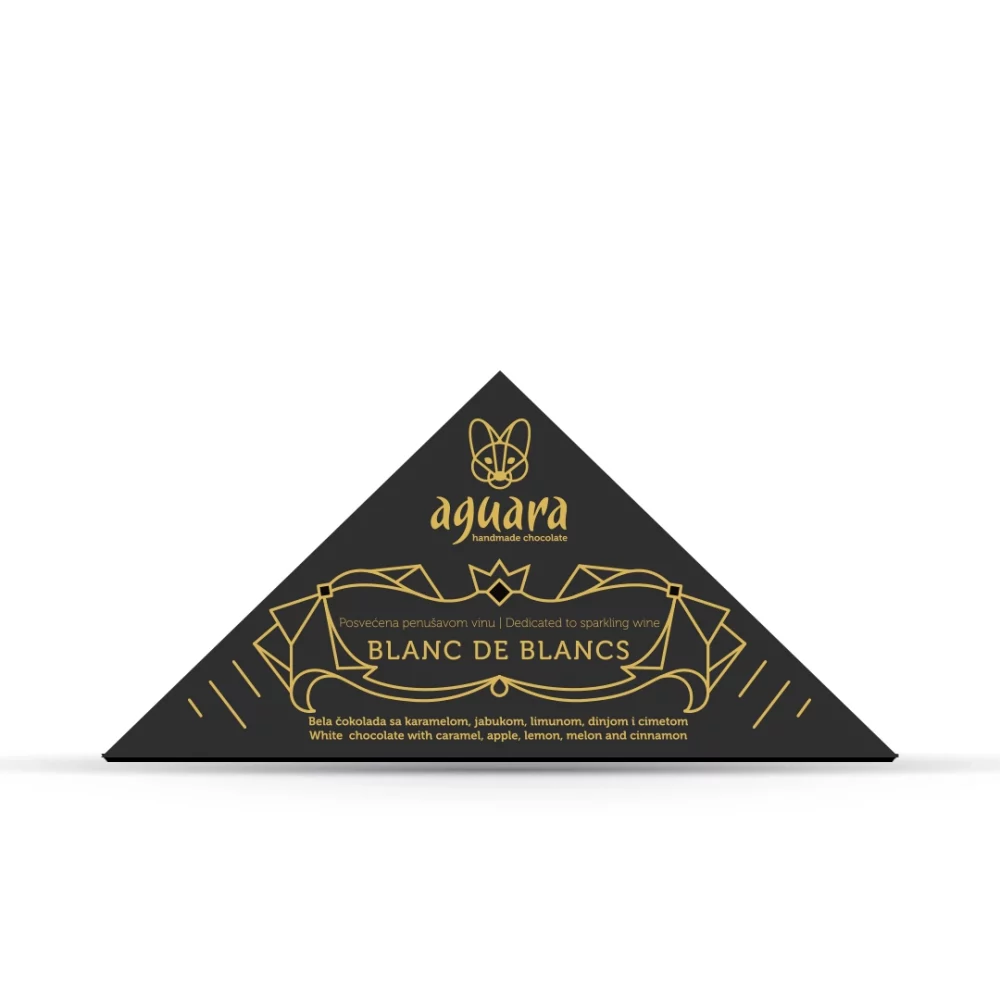 Trouglasta čokolada čokoladeposvećene vinu Blanc de Blancs. Na ambalaži se nalaze linijski elementi koji predstavljaju elemente srpske tradicije.